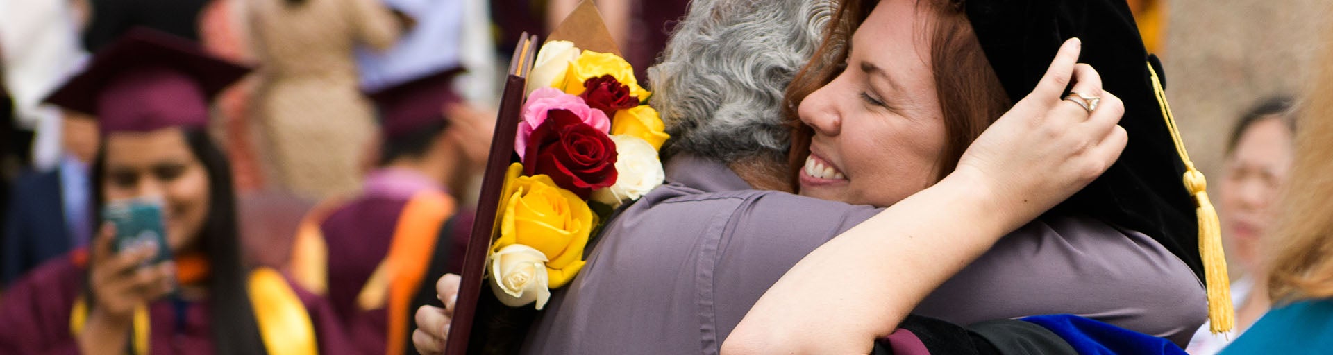 Student hugging their family at graduation